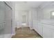 Well-designed bathroom with a glass walk-in shower, double vanity, and wood-look flooring at 16441 Mount Logan Rd, Noblesville, IN 46060