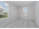 Bright bedroom with plush carpet, neutral walls, and natural light from the double-hung windows at 16441 Mount Logan Rd, Noblesville, IN 46060