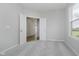 Carpeted bedroom with open double doors and natural light at 16441 Mount Logan Rd, Noblesville, IN 46060
