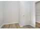 Walk-in closet showcasing built-in shelving and natural wood flooring at 16441 Mount Logan Rd, Noblesville, IN 46060
