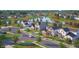 Scenic community street view showcasing new construction homes with a pond, lush landscaping, and sidewalks at 16441 Mount Logan Rd, Noblesville, IN 46060