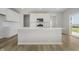 Bright kitchen offers white cabinets, stainless steel appliances, and a large center island at 16441 Mount Logan Rd, Noblesville, IN 46060