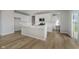 Modern kitchen features white cabinetry, a large island, and stainless steel appliances at 16441 Mount Logan Rd, Noblesville, IN 46060