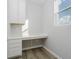 Home office featuring custom built-in cabinets, quartz countertop, and wood flooring at 16441 Mount Logan Rd, Noblesville, IN 46060