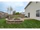 Inviting backyard featuring a stone fire pit area, a patio, and a play set at 16963 Southall Dr, Westfield, IN 46074
