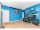 Bedroom with blue walls, dual monitors, and shelves at 16963 Southall Dr, Westfield, IN 46074