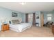 Comfortable main bedroom with plush carpet, a large window, and a cozy reading area at 16963 Southall Dr, Westfield, IN 46074