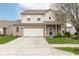 Two-story home with brick and siding, two-car garage, and a well-maintained lawn on a sunny day at 16963 Southall Dr, Westfield, IN 46074