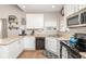 Kitchen featuring stainless steel appliances, white cabinets, and plank flooring at 16963 Southall Dr, Westfield, IN 46074