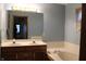 Bright bathroom with double sinks, large mirror, and tub at 1915 Barbie Ct, Franklin, IN 46131