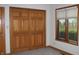 Bedroom with wood closet doors, carpet, window with blinds, and neutral colored walls and trim at 1915 Barbie Ct, Franklin, IN 46131