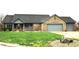 Single-story brick home with three-car garage with beautiful lawn and landscaping to give the home great curb appeal at 1915 Barbie Ct, Franklin, IN 46131