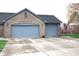 Attached two-car garage with brick facade and space for vehicles, complete with driveway and manicured yard at 1915 Barbie Ct, Franklin, IN 46131