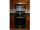 Modern stainless steel oven and microwave surrounded by oak kitchen cabinetry at 1915 Barbie Ct, Franklin, IN 46131
