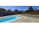Backyard swimming pool is surrounded by concrete and grass and enclosed by a block fence at 1915 Barbie Ct, Franklin, IN 46131