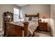 Cozy bedroom featuring a wooden bed frame, decorative bedside lamps, and neutral walls at 19668 Mcdonald Pl, Westfield, IN 46074