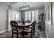 Bright dining room features a modern chandelier, plantation shutters and stylish decor at 19668 Mcdonald Pl, Westfield, IN 46074