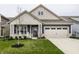 Charming home featuring a well-manicured lawn, a covered front porch, and a neutral color palette at 19668 Mcdonald Pl, Westfield, IN 46074