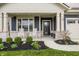 Inviting front porch with rocking chairs and manicured landscaping welcomes you to this charming home at 19668 Mcdonald Pl, Westfield, IN 46074