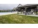 Community pool area featuring covered patio with comfortable seating and well-maintained grounds at 19668 Mcdonald Pl, Westfield, IN 46074