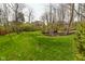 Backyard featuring mature trees and landscaping with an inviting outdoor seating area at 2004 Caledonian Ct, Greenwood, IN 46143