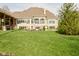 Spacious backyard showcasing a well-manicured lawn with a patio area and mature trees surrounding the home at 2004 Caledonian Ct, Greenwood, IN 46143