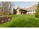 Expansive backyard features an outdoor living area with stone fireplace, BBQ, and lounge chairs at 2004 Caledonian Ct, Greenwood, IN 46143