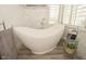 Bathroom highlighting a modern soaking tub near bright window and sleek fixtures at 2004 Caledonian Ct, Greenwood, IN 46143