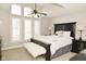 Comfortable bedroom with large windows providing natural light, ceiling fan, and carpeted floors at 2004 Caledonian Ct, Greenwood, IN 46143