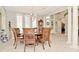 Elegant dining room with a chandelier, architectural columns, and travertine floors at 2004 Caledonian Ct, Greenwood, IN 46143