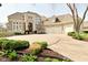 Stately home featuring an arched entry, multi-car garage, manicured landscaping and circular driveway at 2004 Caledonian Ct, Greenwood, IN 46143