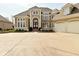 Elegant home with an arched entry, expansive driveway, three-car garage and manicured landscaping at 2004 Caledonian Ct, Greenwood, IN 46143