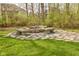 Outdoor fire pit with stone benches set in a stone patio, perfect for outdoor entertaining at 2004 Caledonian Ct, Greenwood, IN 46143