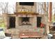 Stone fireplace with wood storage nooks, mantel decor, and comfortable seating arrangement nearby at 2004 Caledonian Ct, Greenwood, IN 46143