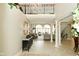 Inviting foyer with grand staircase, soaring ceilings, wrought iron details, and elegant decor at 2004 Caledonian Ct, Greenwood, IN 46143