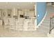 Kitchen island with barstool seating and views of the staircase at 2004 Caledonian Ct, Greenwood, IN 46143
