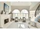 Bright living room boasts soaring ceilings, large windows, a cozy fireplace, and neutral decor at 2004 Caledonian Ct, Greenwood, IN 46143