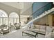 Open-concept living room with staircase, lots of natural light, and views to dining area at 2004 Caledonian Ct, Greenwood, IN 46143