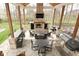 Beautiful outdoor living space featuring a stone fireplace, bar seating, and ample seating areas at 2004 Caledonian Ct, Greenwood, IN 46143