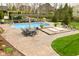 Backyard pool area with a hot tub, ample seating, and a well-maintained yard at 2004 Caledonian Ct, Greenwood, IN 46143