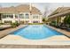 Backyard pool with a view of the home, featuring a clear blue pool and comfortable lounge area at 2004 Caledonian Ct, Greenwood, IN 46143