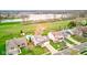 Aerial view of a suburban neighborhood with a lake in the background and homes with well-maintained lawns at 20107 Marie Ct, Noblesville, IN 46062