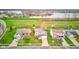 Aerial view of suburban homes with green lawns and a scenic lake in the distance, showing the neighborhood layout at 20107 Marie Ct, Noblesville, IN 46062