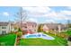 Backyard view featuring a refreshing in-ground pool with slide, landscaped yard, and a well-maintained fence at 20107 Marie Ct, Noblesville, IN 46062