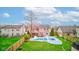 A backyard features a refreshing in-ground pool with a slide, surrounded by a well-manicured lawn and mature trees at 20107 Marie Ct, Noblesville, IN 46062