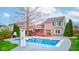 Backyard view showcases an in-ground pool with a slide and ample space for outdoor entertainment and relaxation at 20107 Marie Ct, Noblesville, IN 46062