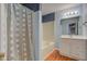 Neat bathroom featuring a tub and a vanity with drawers, illuminated by a sleek light fixture at 20107 Marie Ct, Noblesville, IN 46062