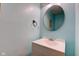 Powder room featuring a white vanity and round mirror at 20107 Marie Ct, Noblesville, IN 46062