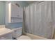 Cozy bathroom featuring a tub with a blue patterned shower curtain and a vanity with storage at 20107 Marie Ct, Noblesville, IN 46062