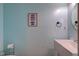 Cozy powder room featuring a stylish surfboard art piece and round mirror at 20107 Marie Ct, Noblesville, IN 46062